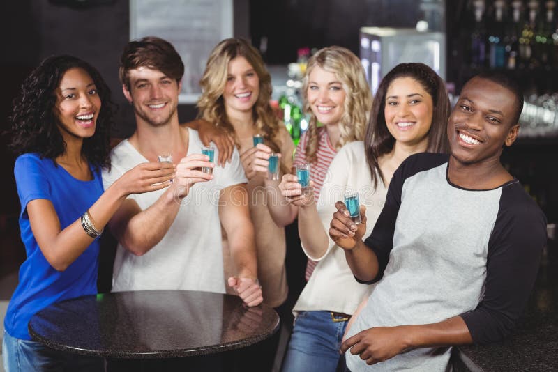 Group of friends having shots stock photography