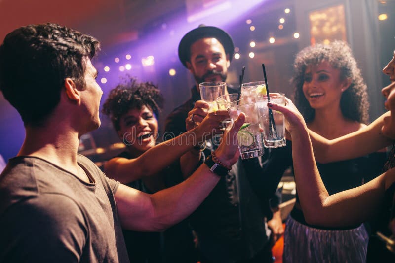 Group of friends at nightclub celebrating with drinks stock photos Group of friends at nightclub celebrating with drinks stock photos