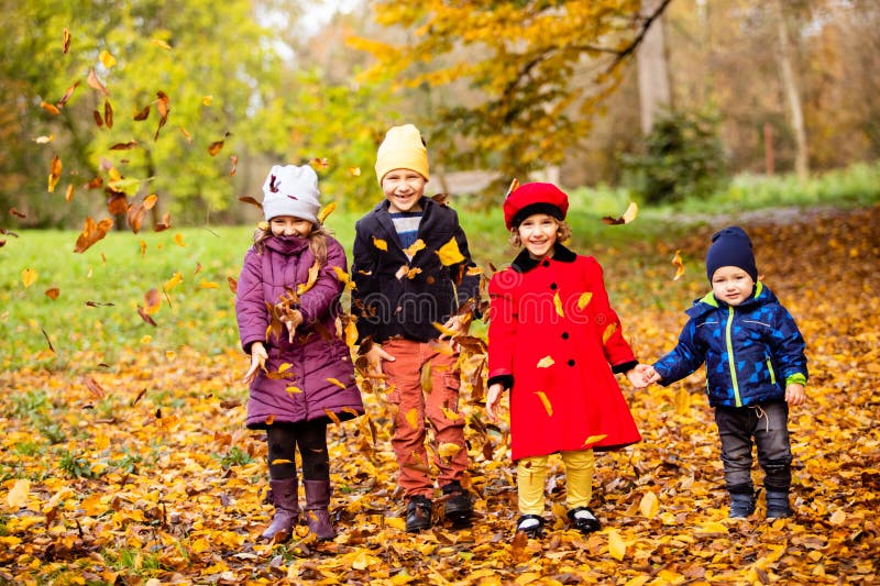 Group of friends play in autumn park stock images