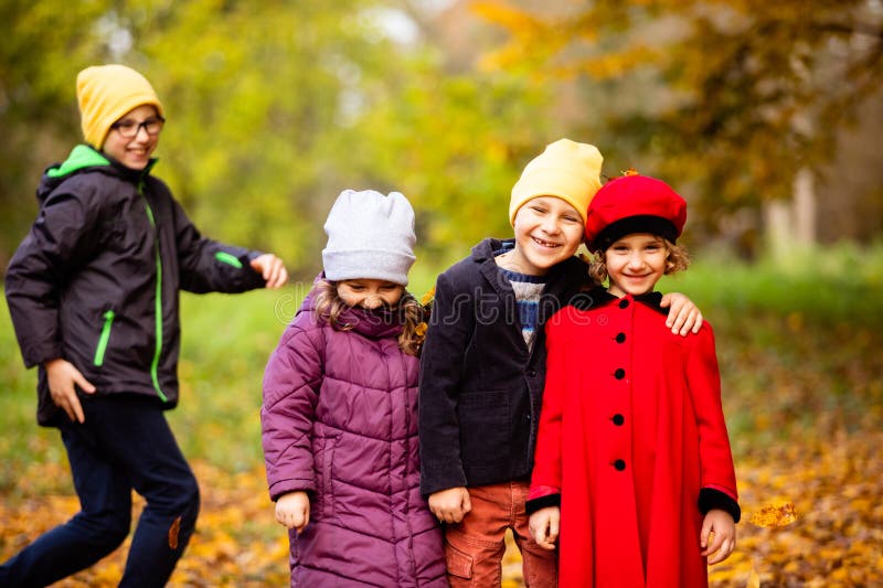 Group of friends play in autumn park stock images