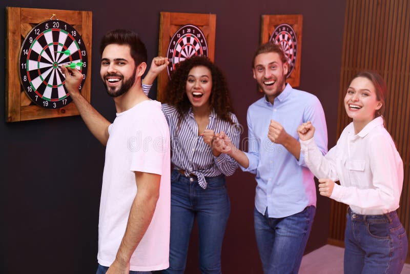 Group of friends playing darts stock photos