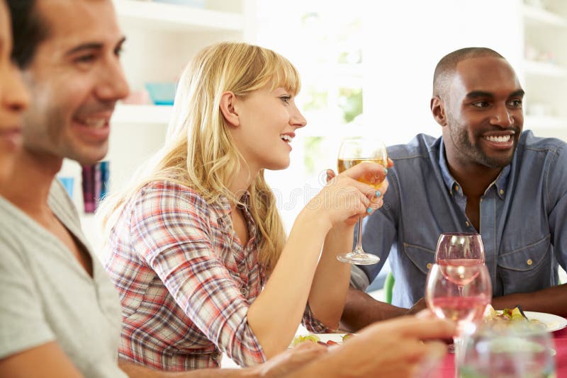Group Of Friends Sitting Around Table Having Dinner Party Stock Image