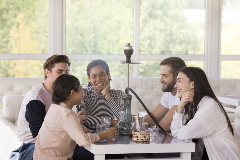 Group of friends smoking shisha, hanging out together