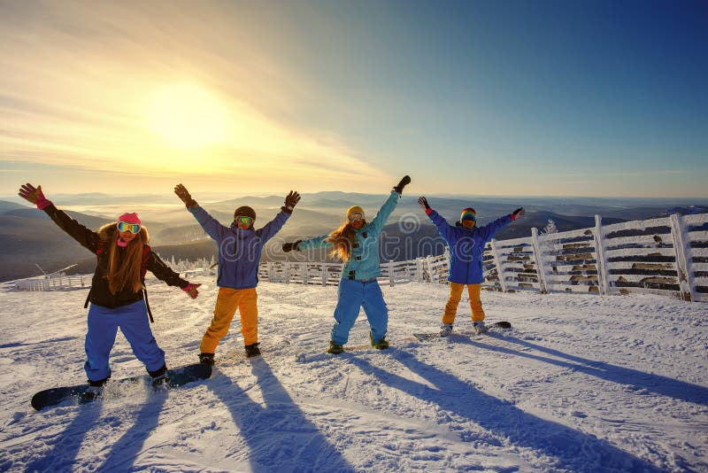Group of friends snowboarders having fun on the top of mountain stock images