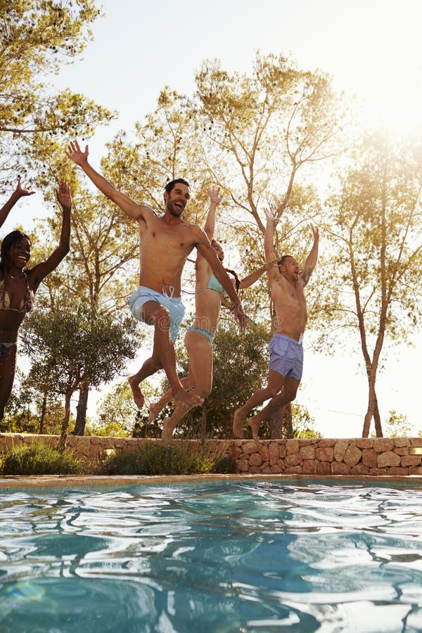 Group of Friends on Vacation Jumping into Outdoor Pool Stock Photo ...