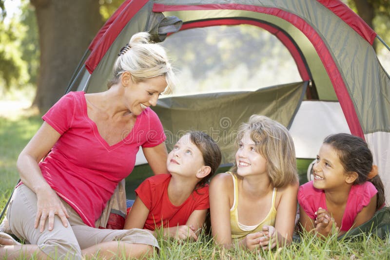 Group Of Girls With Mother Having Fun In Tent In Countryside stock photography Group Of Girls With Mother Having Fun In Tent In Countryside stock photography