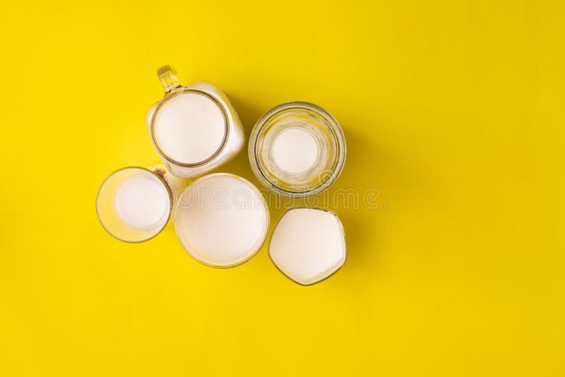 Group glass of milk on yellow background with copy space royalty free stock images
