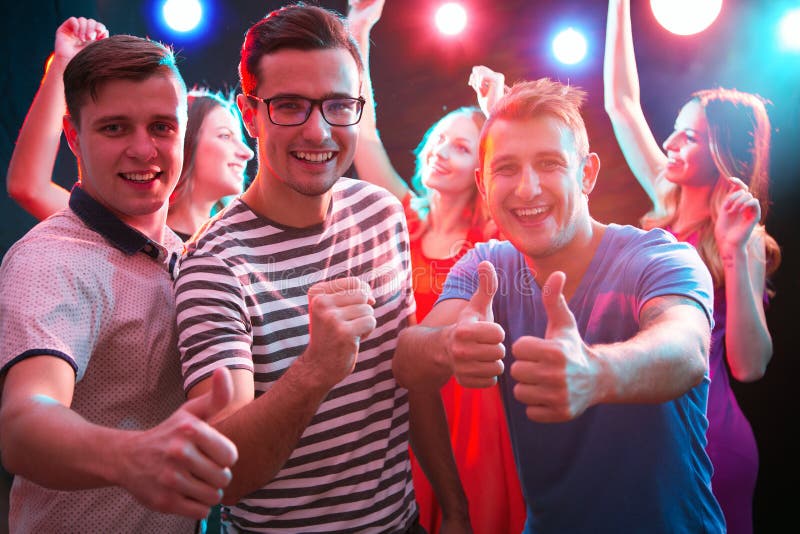 Group of guys dancing in the night club