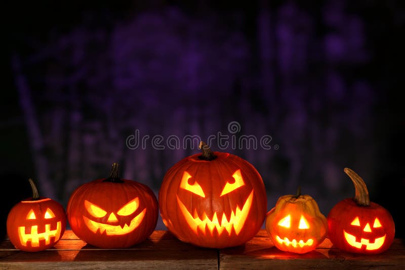 Halloween Jack o Lanterns at night against a spooky background