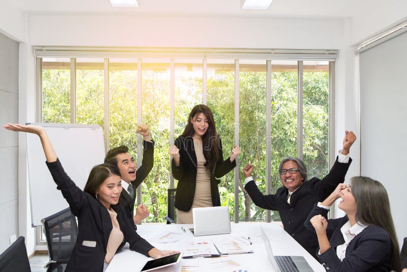 Group of happy business people cheering in office. Celebrate success. Business team celebrate a good job in the office. Asian. People royalty free stock images