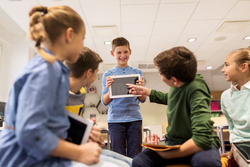 Group of happy children with tablet pc at school