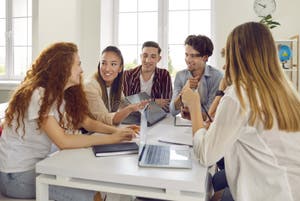 Group Of Happy College Or University Students Working On A Project And 