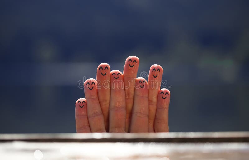 Group of happy finger smileys on the beach 4