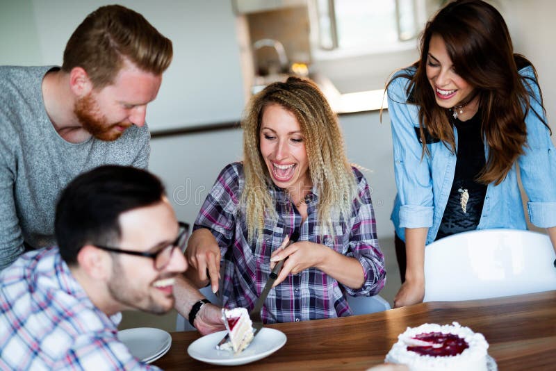 Group of happy friends celebrating birthday at home together. Group of friends celebrating birthday at home together royalty free stock images Group of happy friends celebrating birthday at home together. Group of friends celebrating birthday at home together royalty free stock images