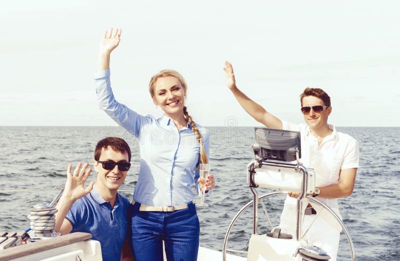 Group of happy friends having a party on a yacht and drinking ch. Leisure, champagne.