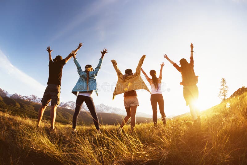 Group happy friends mountains sunset raised arms stock photography