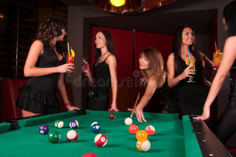 Group of happy girls playing in billiard