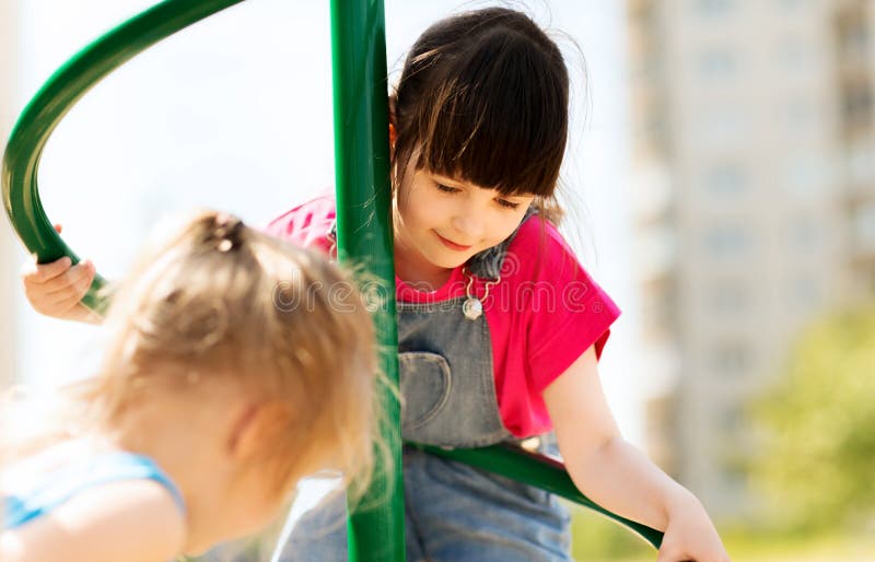 Group of happy little girls on children playground