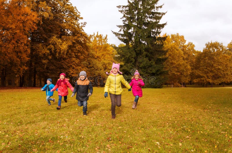 Group of happy little kids running outdoors