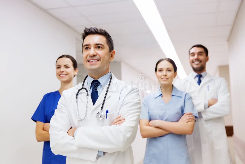 Group of happy medics or doctors at hospital