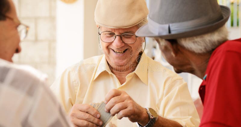 Group Of Happy Seniors Playing Cards Game