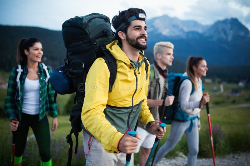 Group of Hikers with Backpacks and Sticks Walking on Mountain. Friends ...