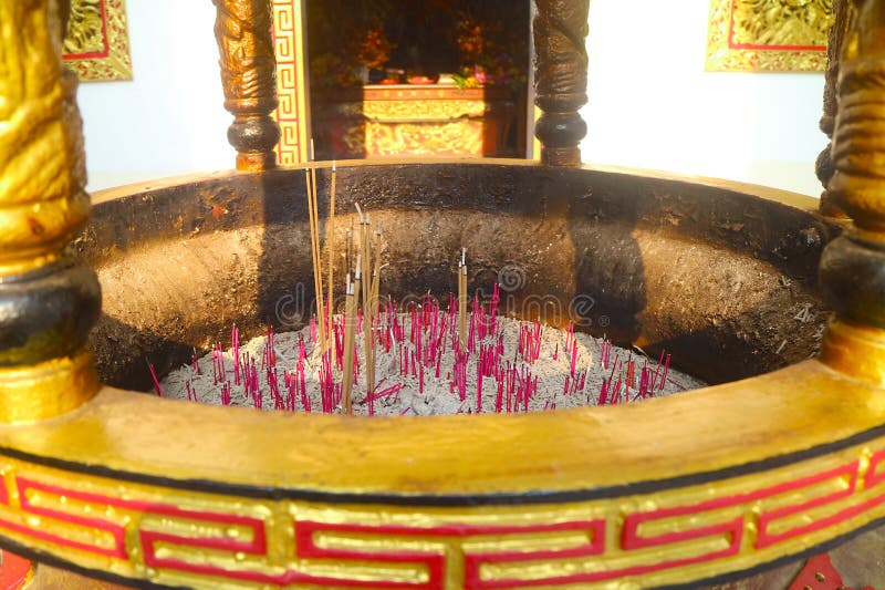 Group of Incenses Burning in a Golden Burner in Chinese Buddhist Shrine