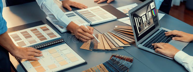Group of interior architect at table choosing material selection. Insight royalty free stock image