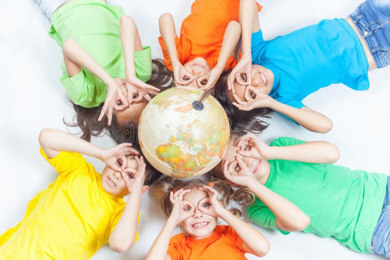 Group of international funny kids with globe earth. Fly gesture. Smiling. School children learn geography. Travel and adventure, world. Ecology. Pure earth. International Children's Day