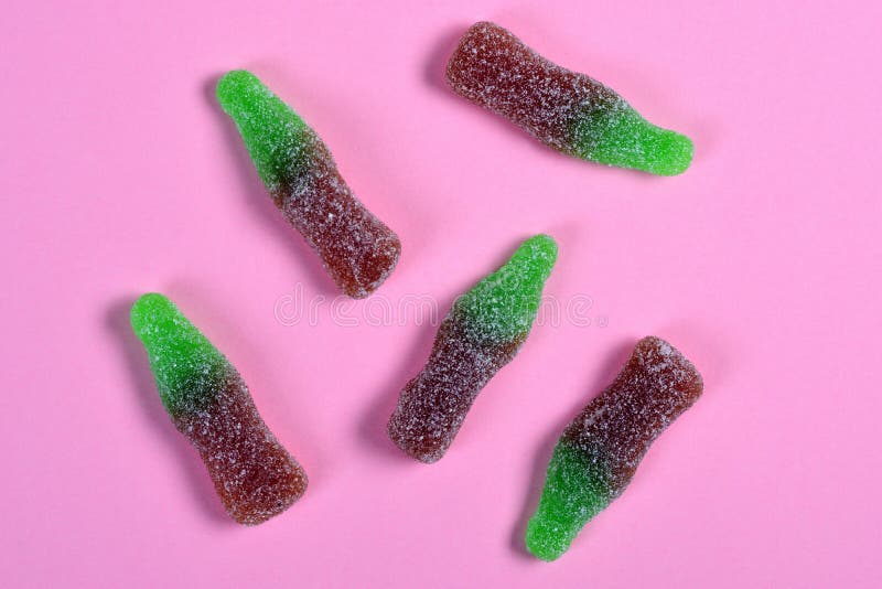 Group of Jelly Candies Coke Bottles on Pink Background Stock Image
