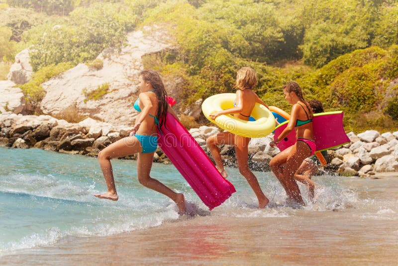 Group of kids girls run into the sea water stock photography Group of kids girls run into the sea water stock photography