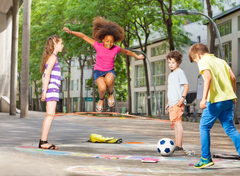 Group of kids elastic ropes together on the street. Group of kids elastic ropes together on the street