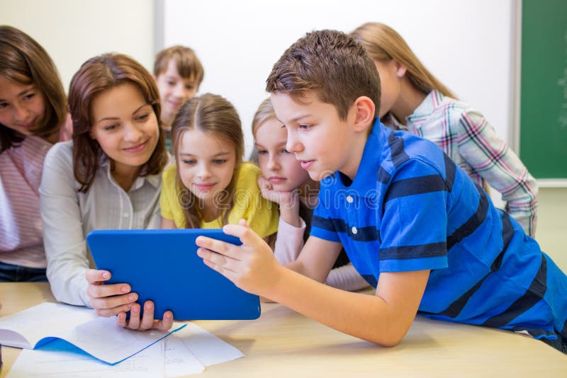 Group of kids with teacher and tablet pc at school