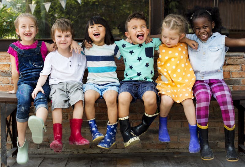 Group of kindergarten kids friends arm around sitting and smiling fun