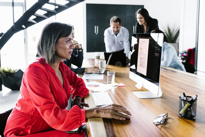 Group of latin office employees developing business strategies using digital devices at workplace in Mexico City stock images