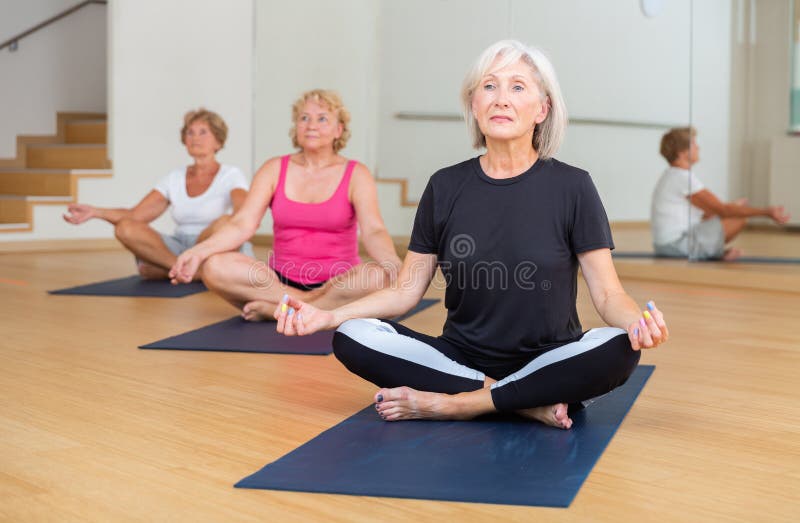Group of Mature Women Meditates in the Half-lotus Position Stock Image ...