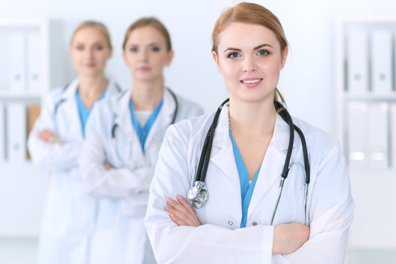 Beautiful Female Medical Doctor Standing at Hospital in Front of Medical  Group. Physician is Ready To Help Patients Stock Photo - Image of help,  diagnosis: 114385478