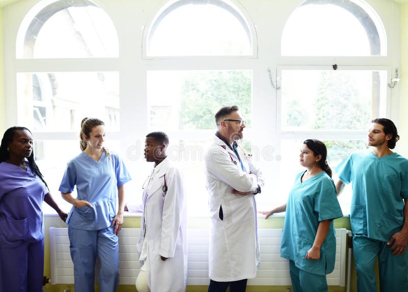 Group of medical professionals discussing in the hallway of a hospital