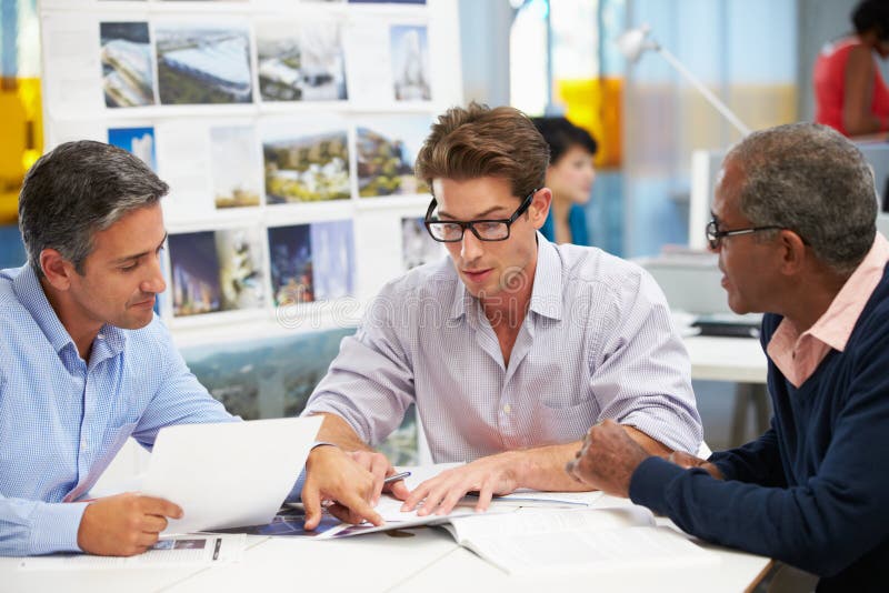 Group Of Men Meeting In Creative Office Talking