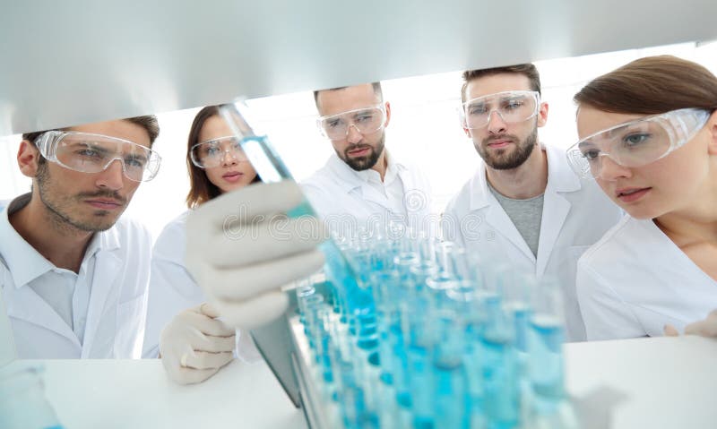 Background image is a group of microbiologists studying the liquid in the glass tube.