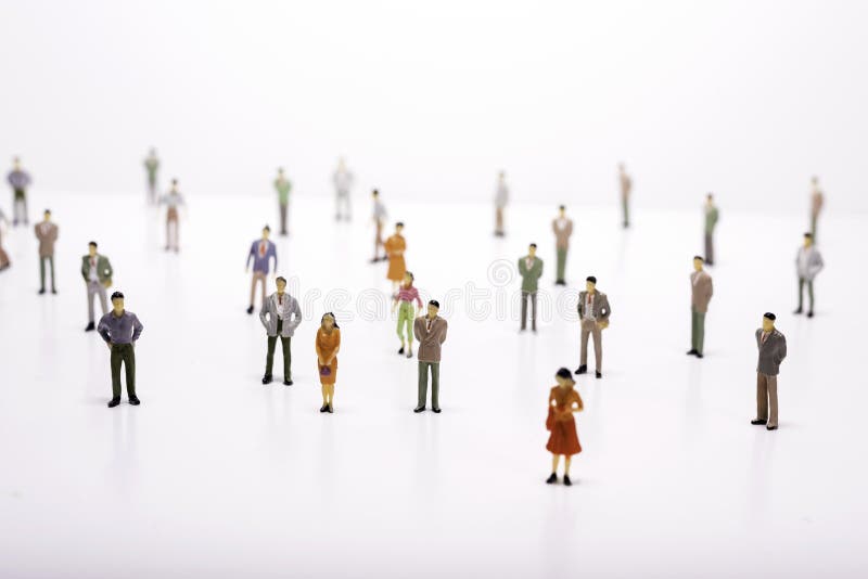 Group of miniature people over white background.