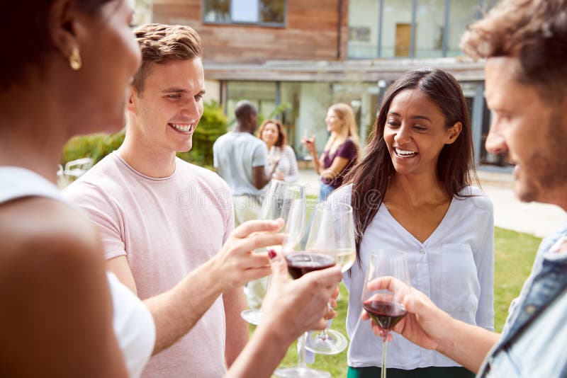 Group of Multi-Cultural Friends Making a Toast at Outdoor Summer Garden ...