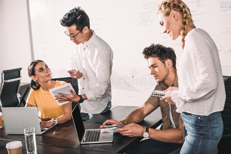 group of multiethnic business colleagues having meeting with laptops and digital tablet at modern royalty free stock image group of multiethnic business colleagues having meeting with laptops and digital tablet at modern royalty free stock image