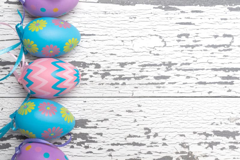 A group of pastel colored Easter eggs on a white wooden background royalty free stock photos A group of pastel colored Easter eggs on a white wooden background royalty free stock photos
