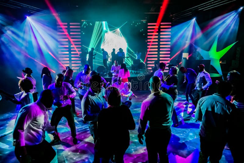 Group of People Dancing on a Dance Floor in Dark Night Club Environment ...