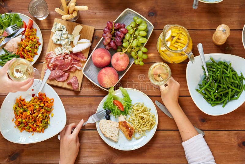 Group of People Eating at Table with Food Stock Photo - Image of ...