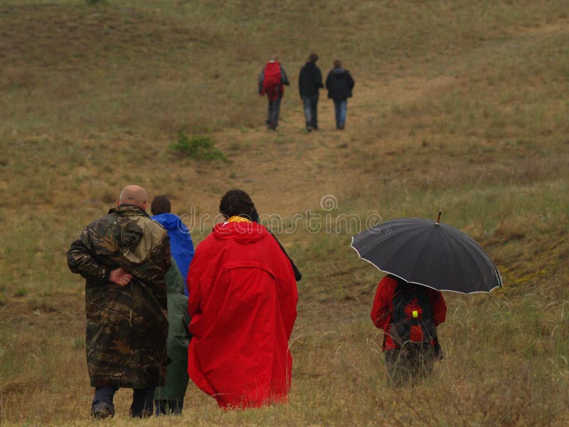 A group of people on an excursion during a bad weather stock image A group of people on an excursion during a bad weather stock image