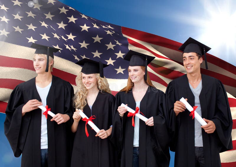 Group Of People In Graduation Gown Standing Against American Flag Stock