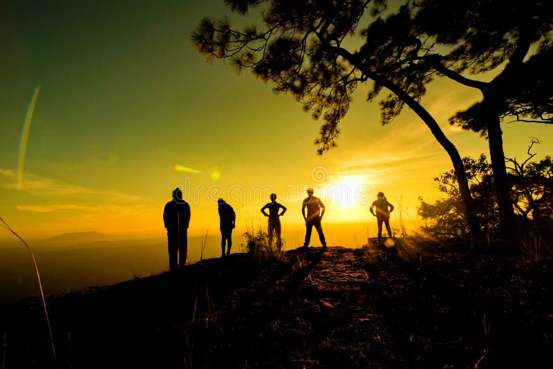 A group of people, Happy hiking standing on a cliff side with arms raised up. Female traveler standing stock images, royalty-free photos and pictures