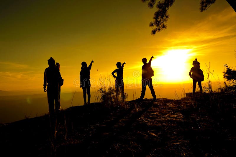 Group of people, Happy hiking standing on a cliff side with arms raised up. Female traveler standing stock images, royalty-free photos and pictures